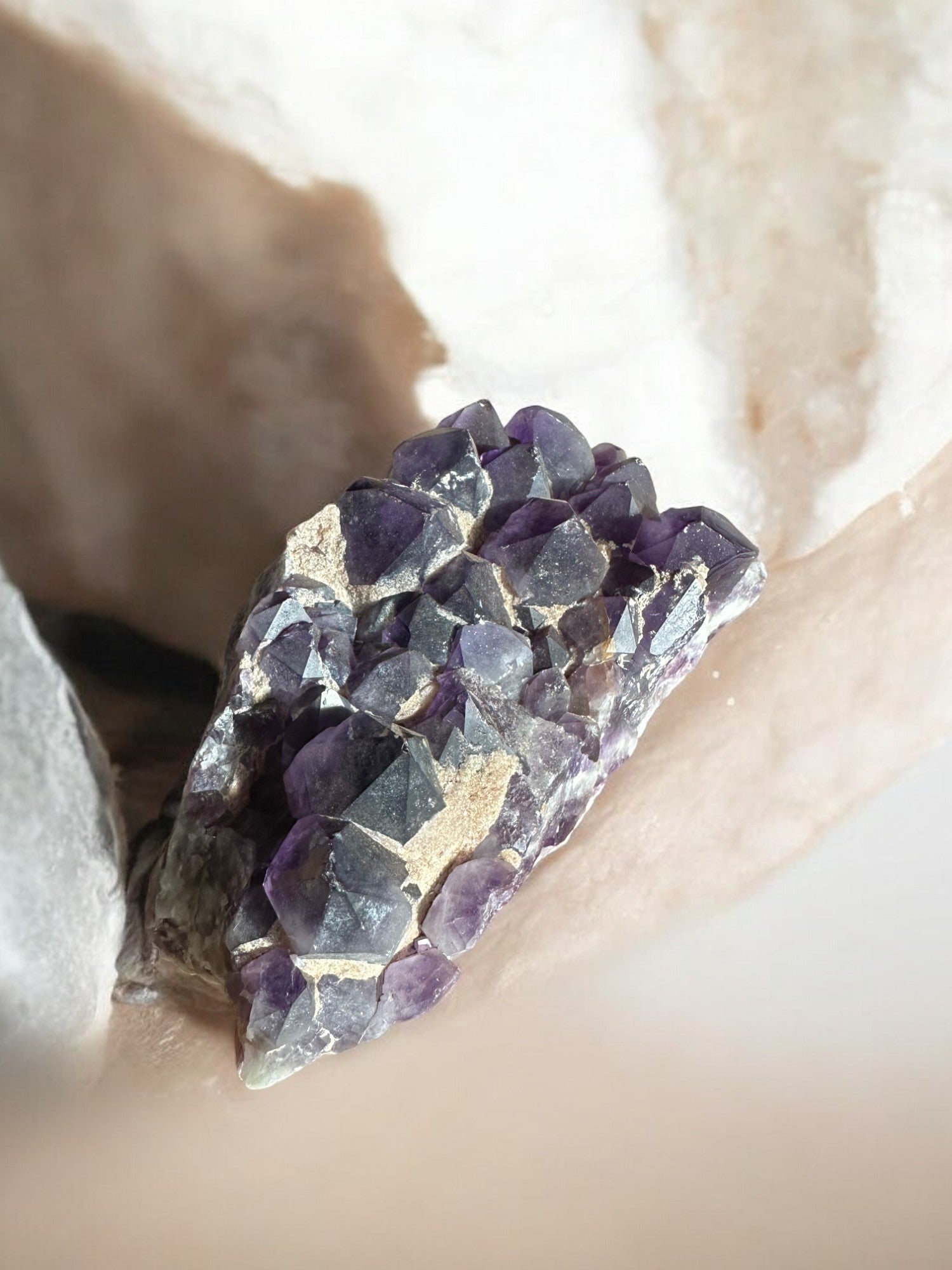 Amethyst raw gemstone with sand on it