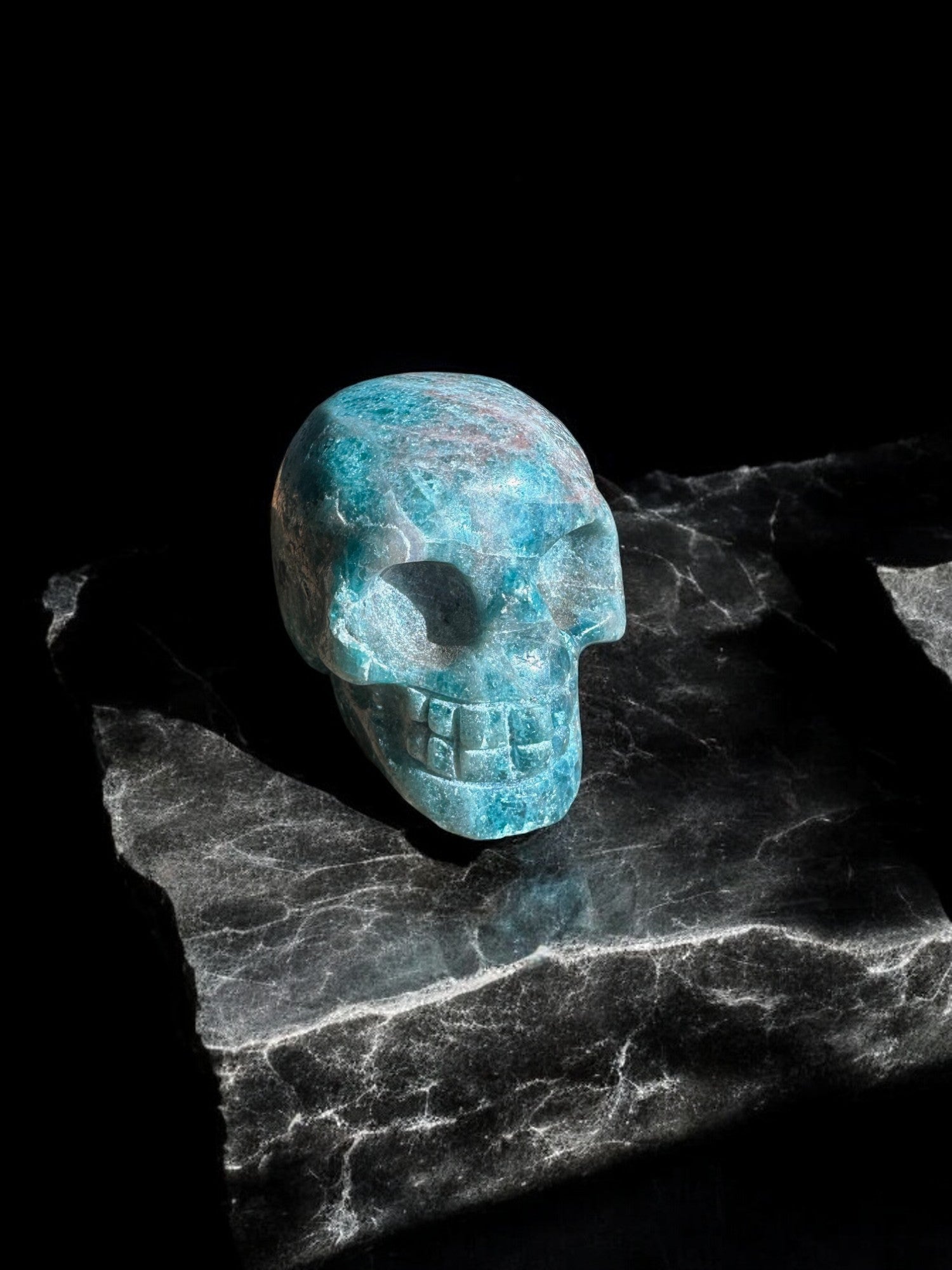 Blue apatite crystal figurine in skull shape