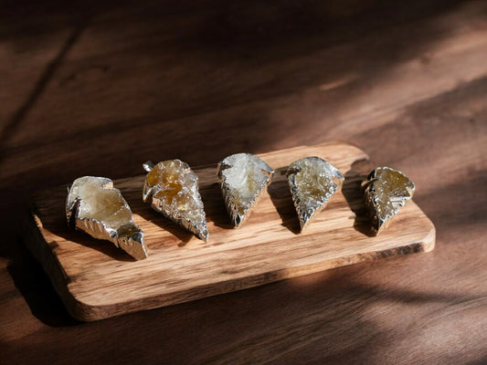 Citrine crystal pendants on a wooden slab