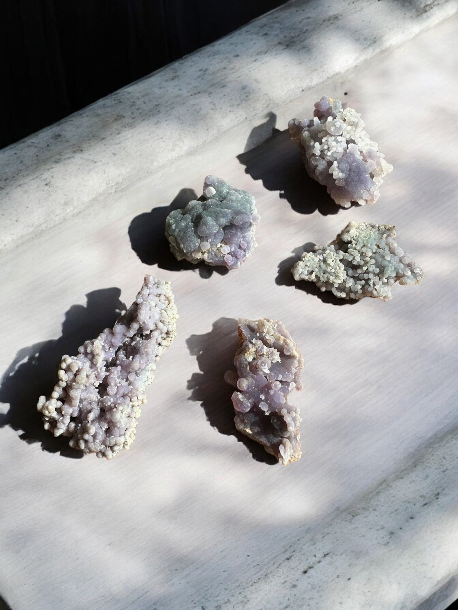 Grape agate raw crystals on a slab