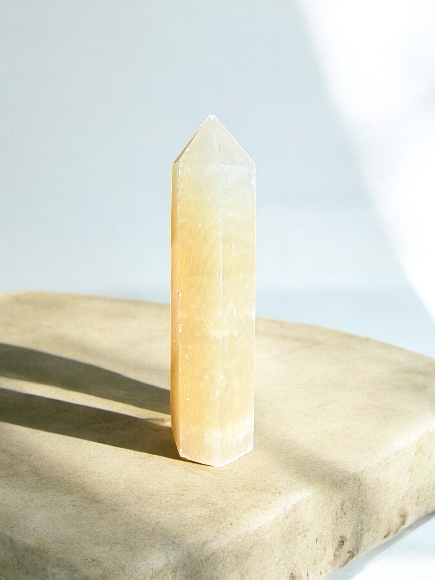 Orange calcite crystal tower back side