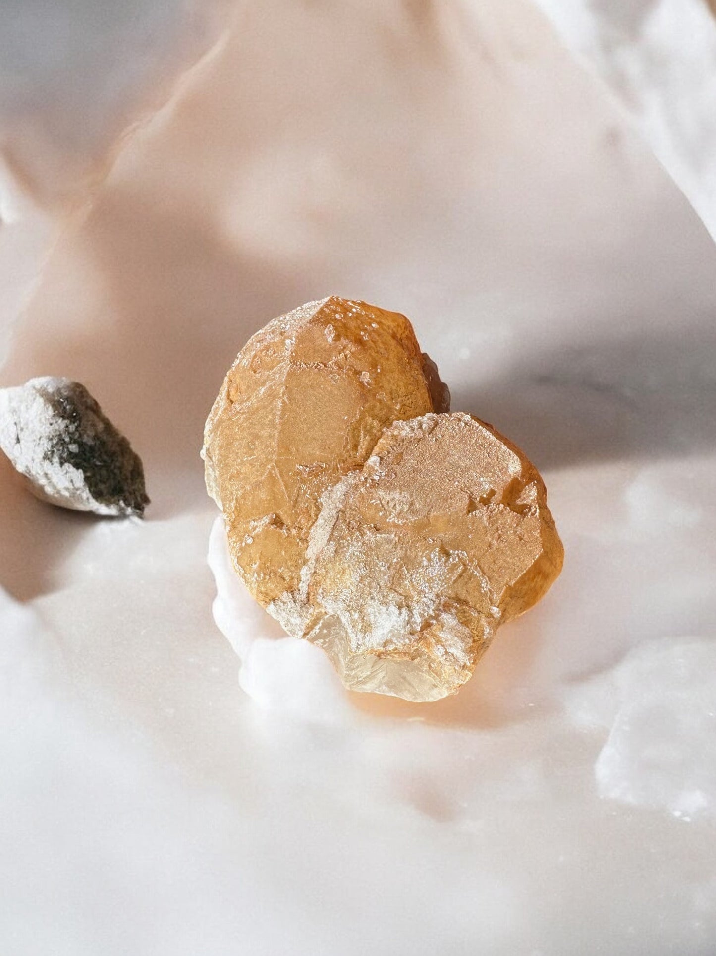 Orange calcite raw crystal on a table