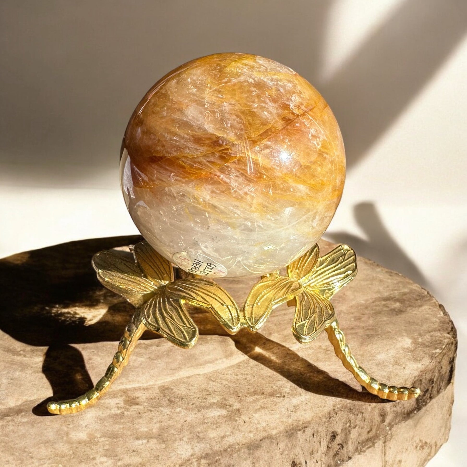 golden healer sphere front view on a stand