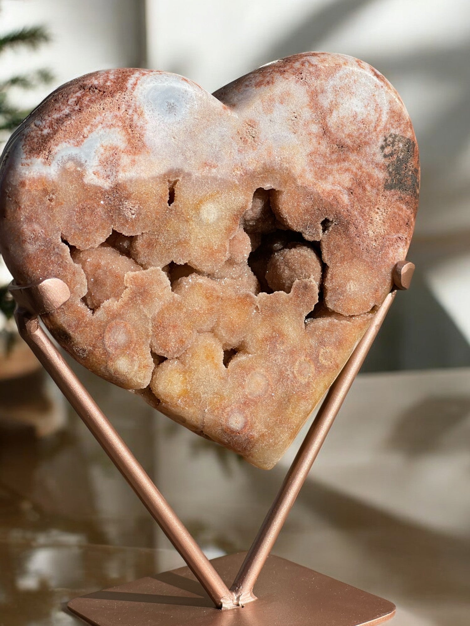 Pink amethyst crystal heart on a table