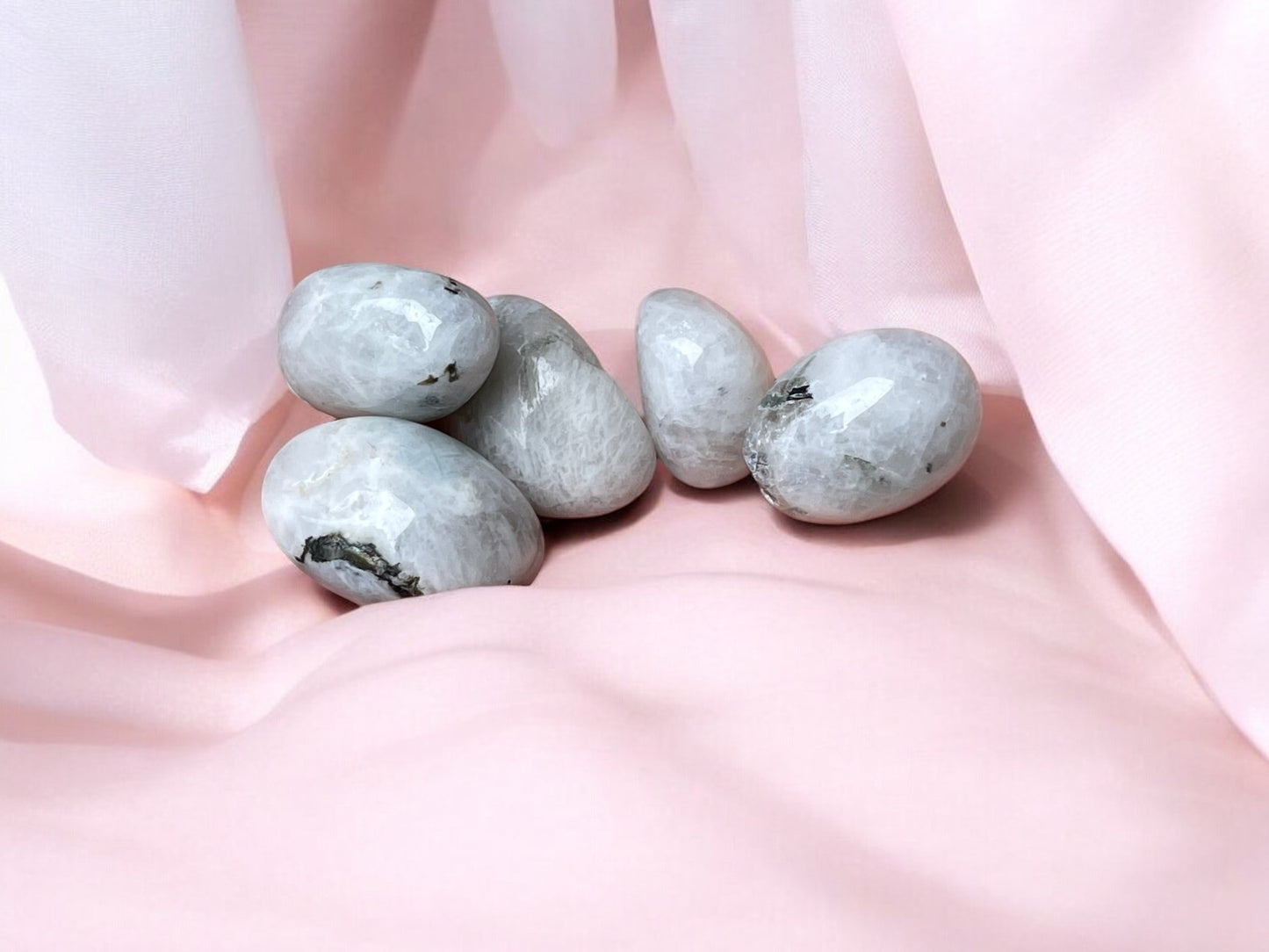 Rainbow moonstone tumbled stones on pink