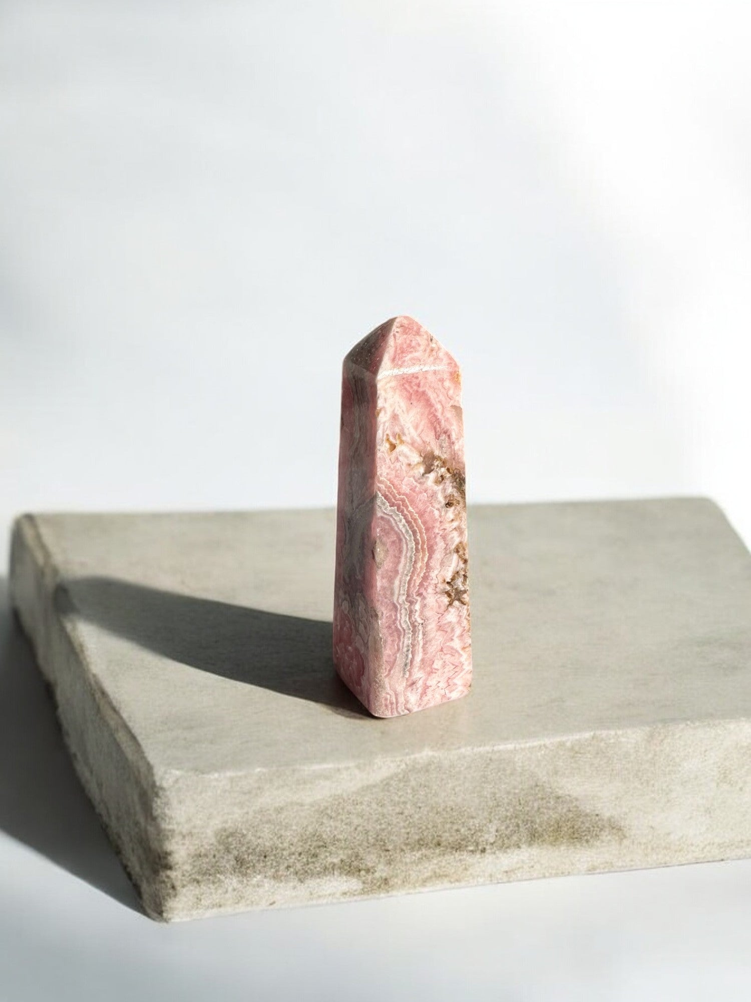 Rhodochrosite crystal tower with brown inclusions