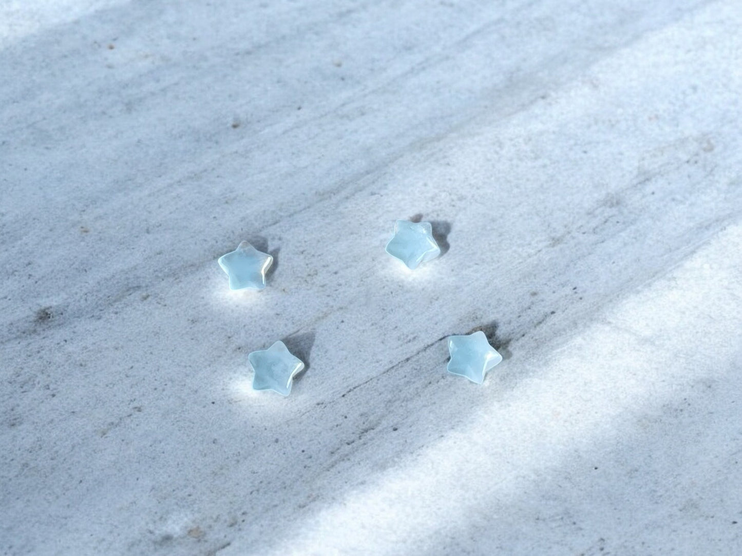 Aquamarine mini crystal stars on concrete