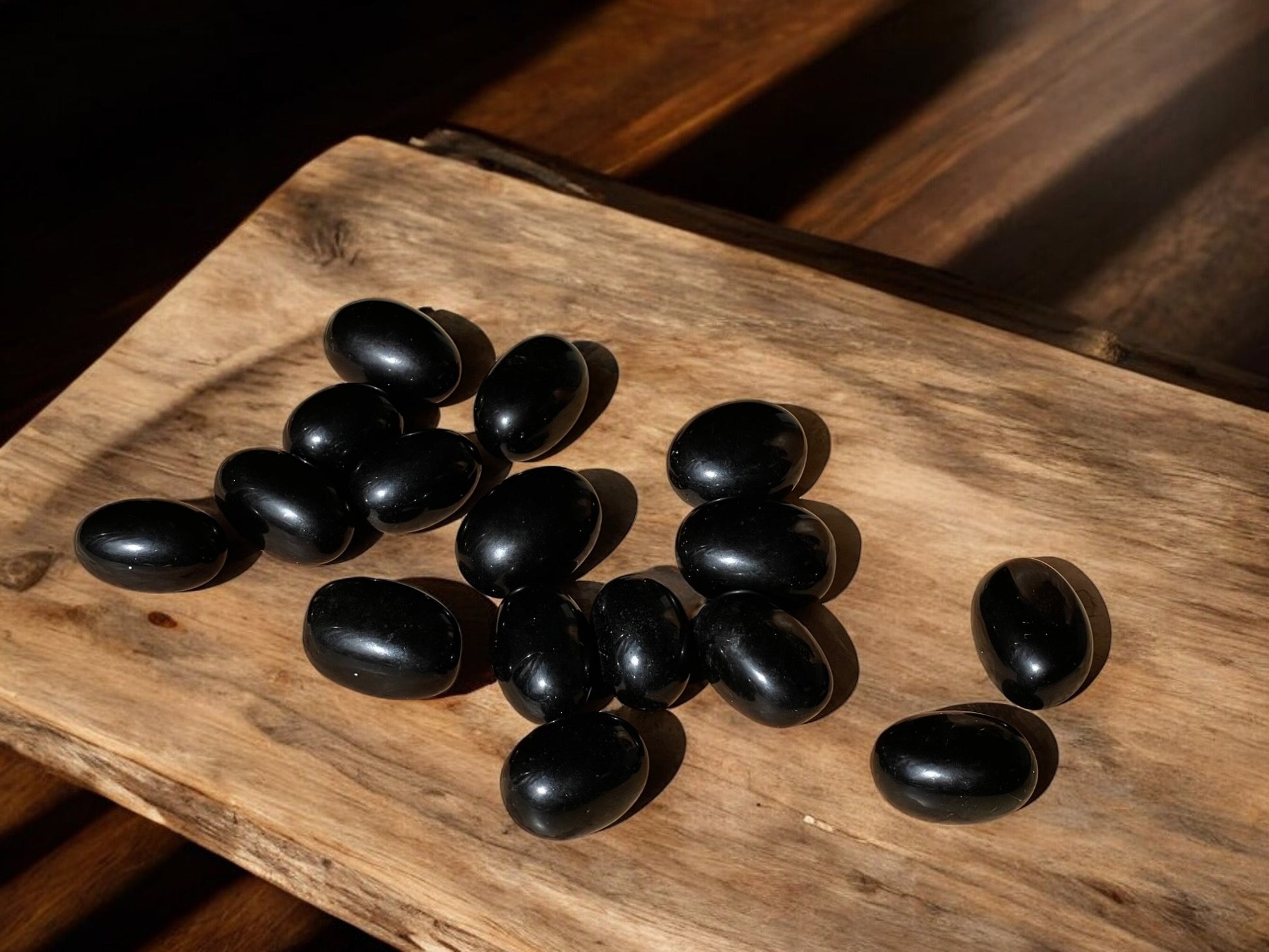 Black obsidian tumbled crystals on a slab