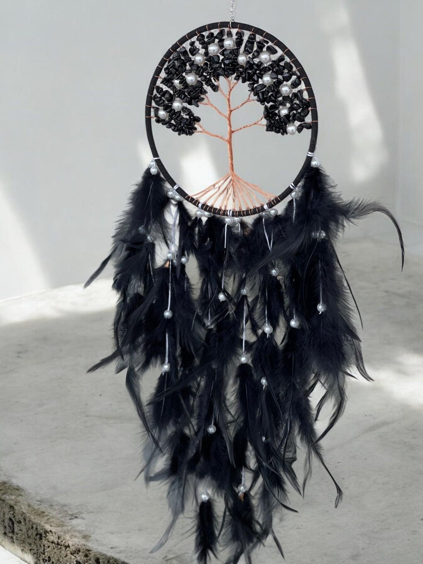 Black onyx crystal dreamcatcher in a room