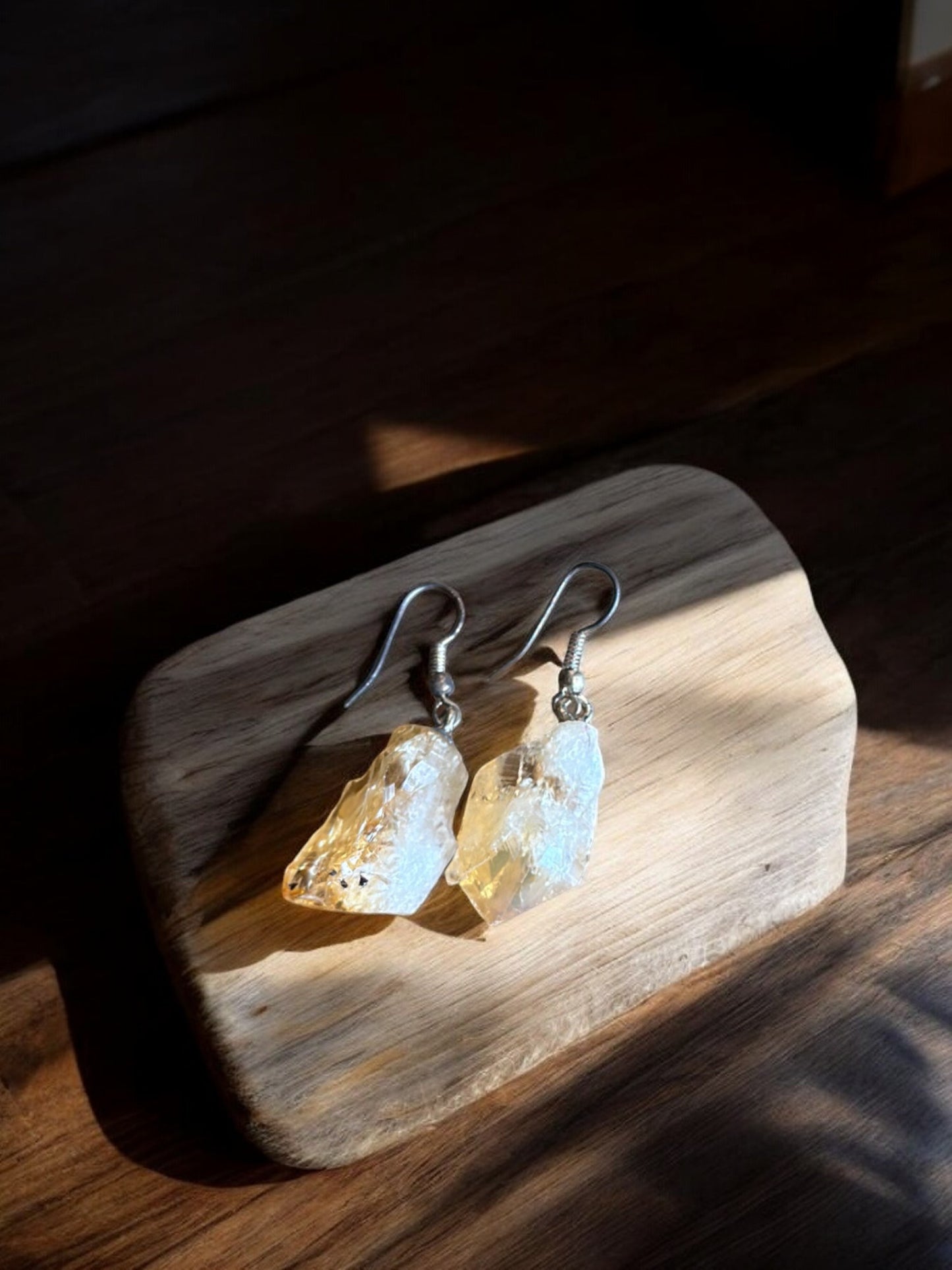 Citrine crystal earrings on a wood slab