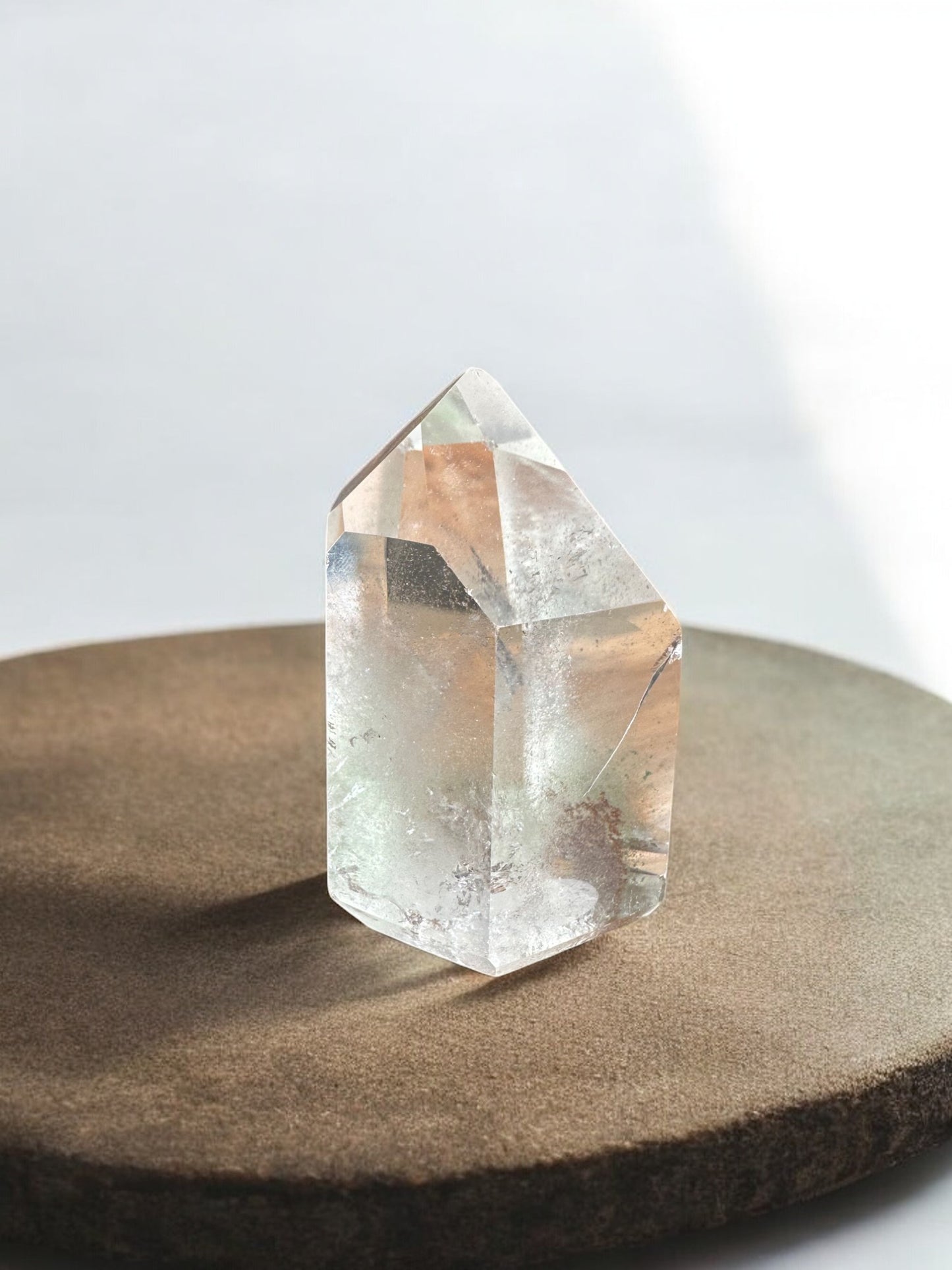 Clear quartz crystal tower with inclusions