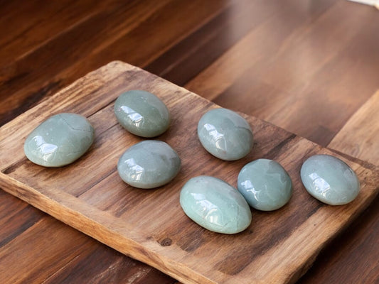 Green aventurine palm stones on slab