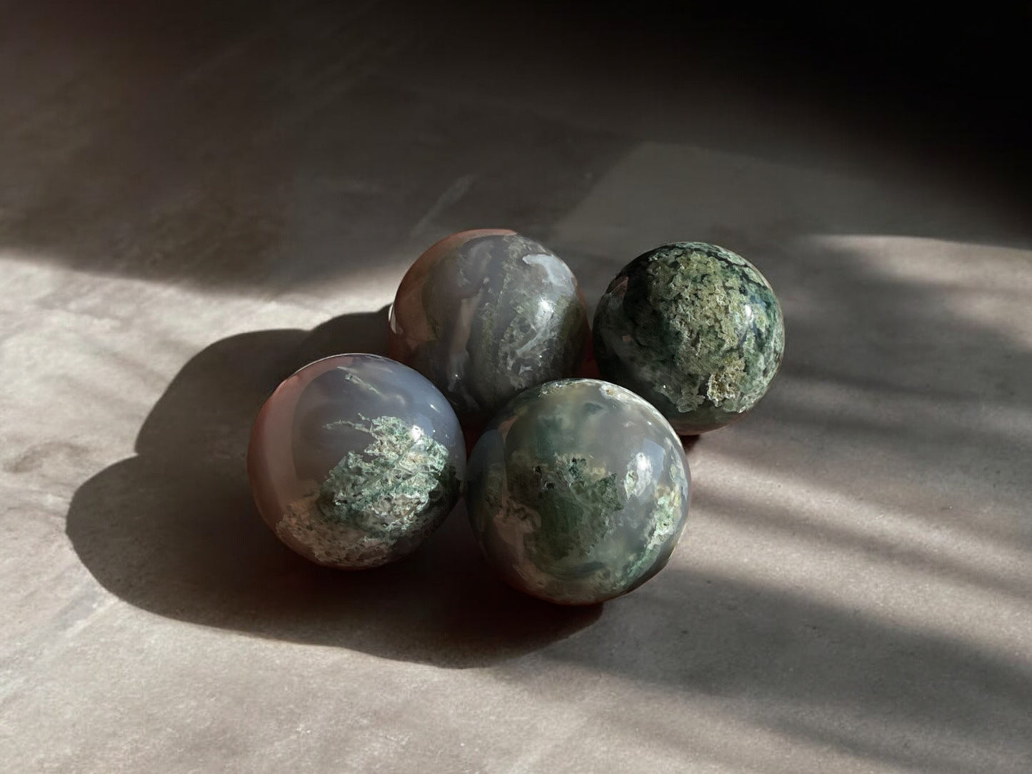 moss agate mini crystal spheres on concrete