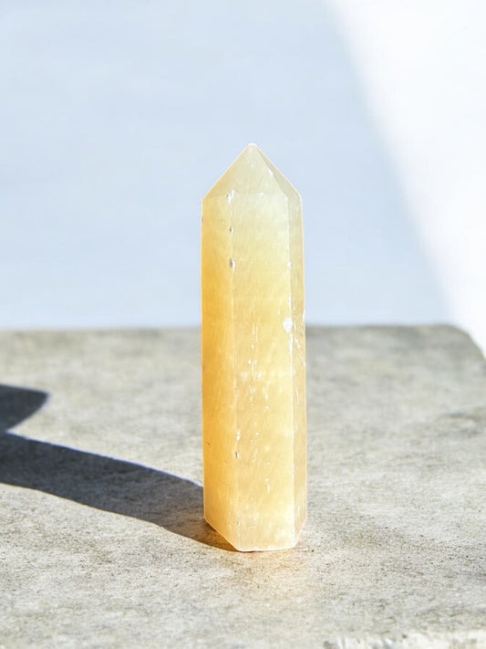 Orange calcite crystal tower front side