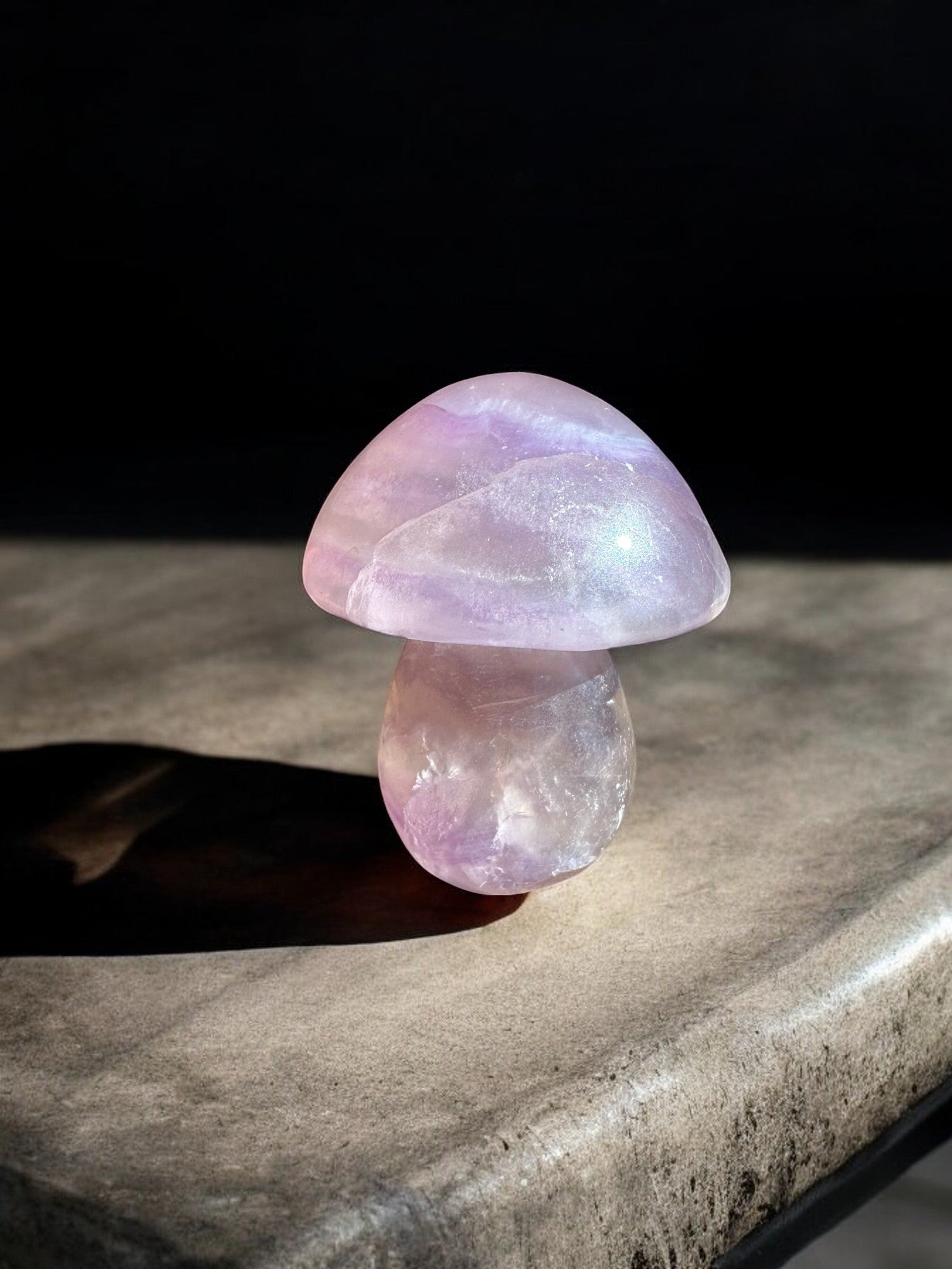 Purple fluorite mushroom crystal figurine on a slab