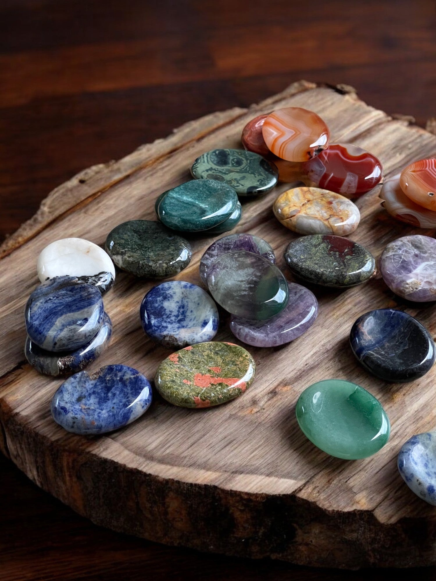 Worry stones on a wooden slab